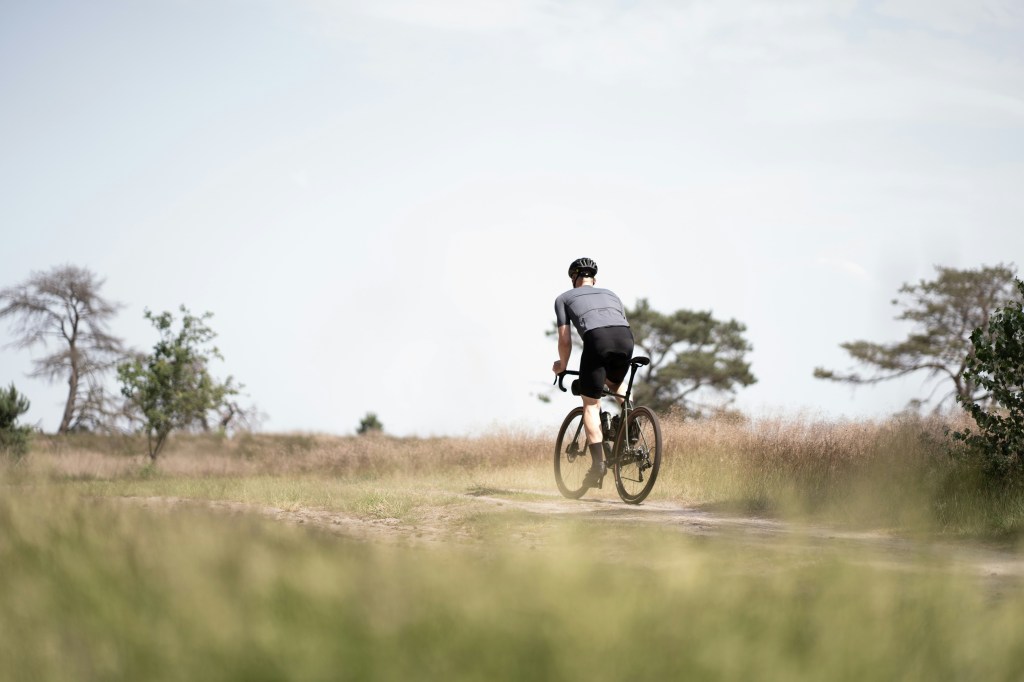 Over 50 gravel cyclist enjoying low-impact ride on UK gravel track in the Cotswolds
